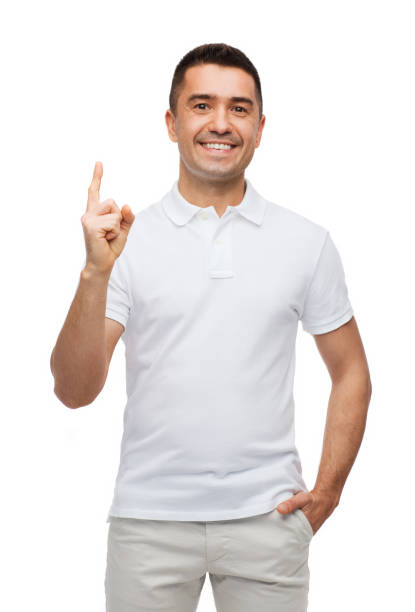 smiling man pointing finger up - finger raised imagens e fotografias de stock