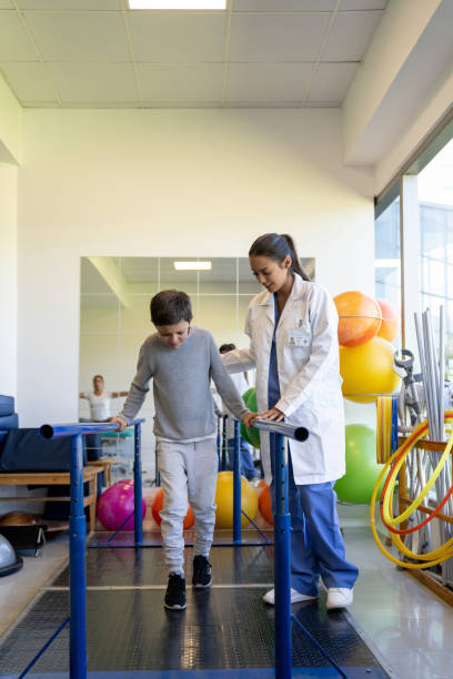 istock Boy doing physical therapy with help of a doctor 1213238679