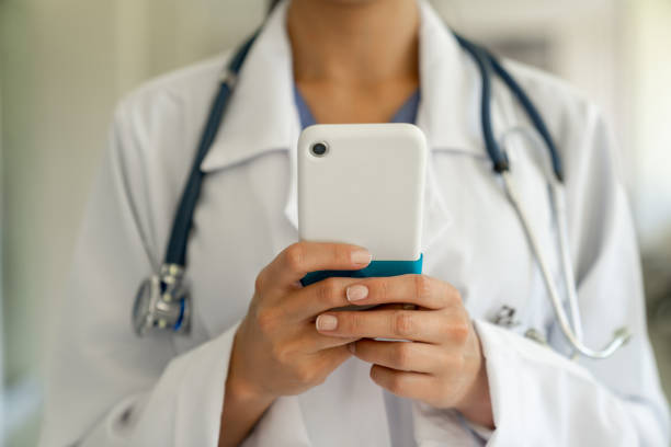 istock Doctor text messaging on a cell phone at the hospital 1213241352