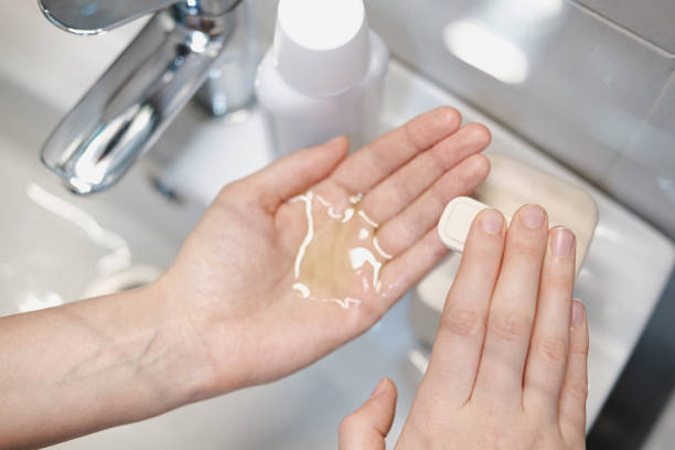 istock Cleaning hands with sanitizer in bathroom. 1213242405