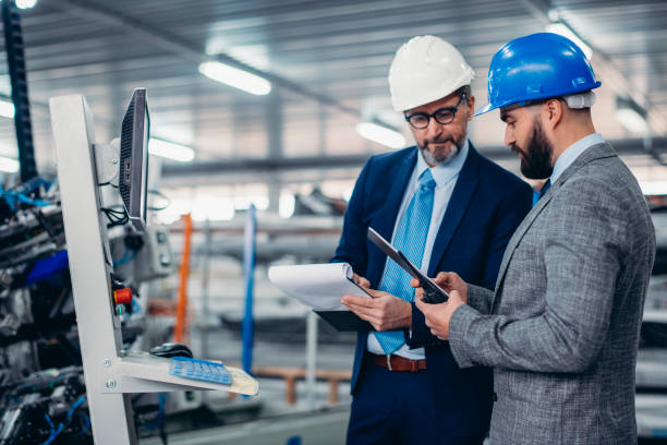 istock Engineers talking while inspecting machinery stock photo 1213242807