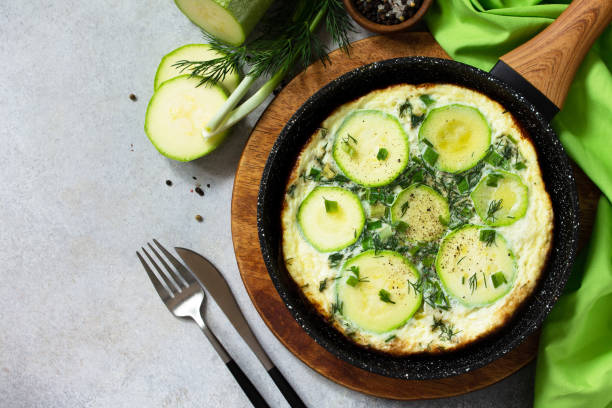 istock Breakfast. Summer omelet with zucchini and herbs on a stone or slate table. Top view flat lay. Copy space. 1213242813