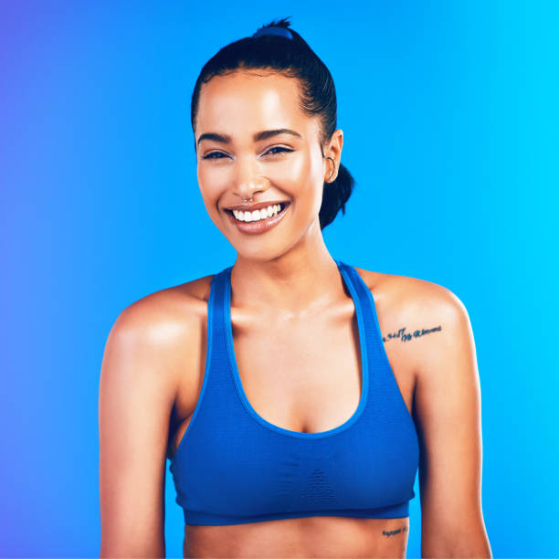 Studio portrait of an attractive young sportswoman posing against a blue background