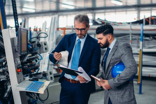istock Engineers talking while inspecting machinery stock photo 1213245177