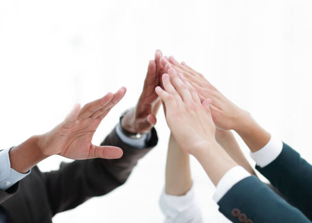 istock closeup.business team giving each other a high five. 1213247680