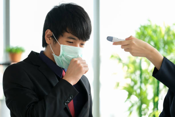istock Women in the office use thermoscan to check temperature 1213250409