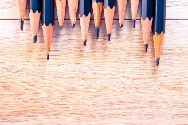 istock black pencils isolated on wood surface background.Close up. 1213256379