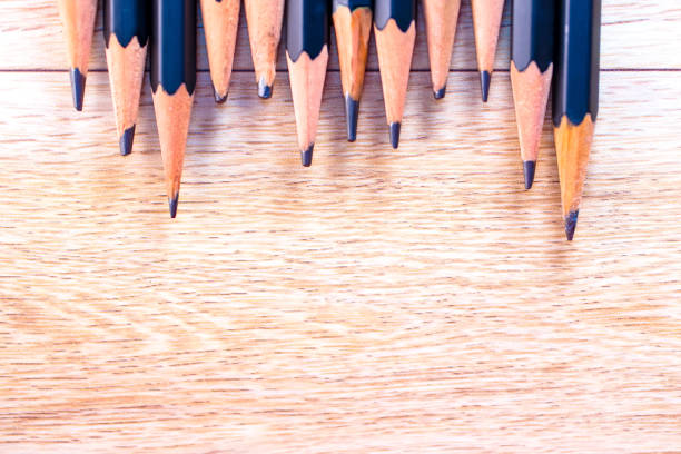 istock black pencils isolated on wood surface background.Close up. 1213258435