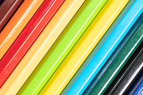 Wooden colored pencils lined up in a row on tray