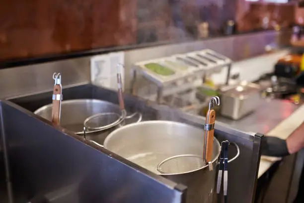 Photo of Cooking asian noodle in hot water in ramen shop