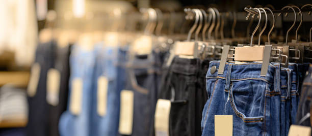 istock Jeans hanging on rack in clothes shop 1213259811