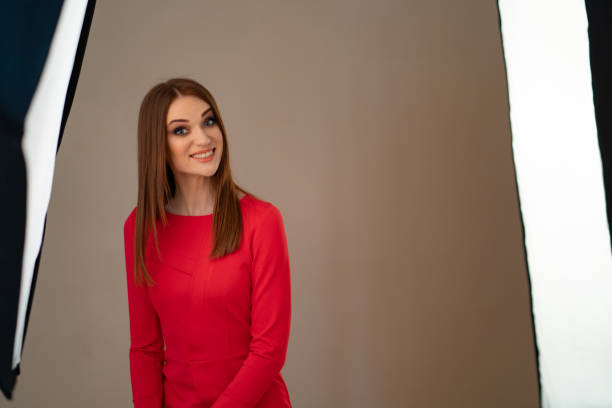 istock backstage photo shoots. girl in red in Studio. 1213261505
