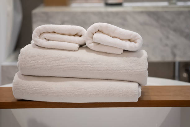 istock White bath towels are stacked on a bathroom shelf 1213262282