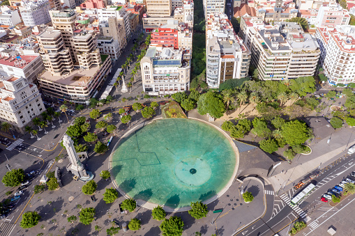 Drone aerial view of Plaza de Espana, largest and main square of Santa Cruz, capital of Tenerife, with large artificial lake and fountain spain