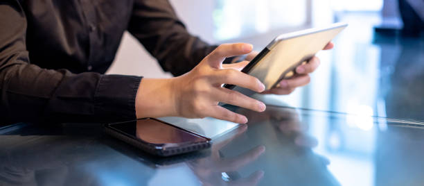 Businessman hand using digital tablet in office Businessman hand using digital tablet in office meeting room. Male entrepreneur reading news on social media app. Online marketing and Big data technology for E-commerce business. e reader photos stock pictures, royalty-free photos & images