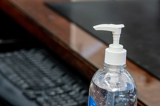 Close-Up Shot of Gel Hand Sanitizer with Alcohol and Aloe Vera In an Office Environment To Prevent the Spread of COVID SARS nCoV 19 Coronavirus Swine Flu H7N9 Influenza Illness During Cold and Flu Season