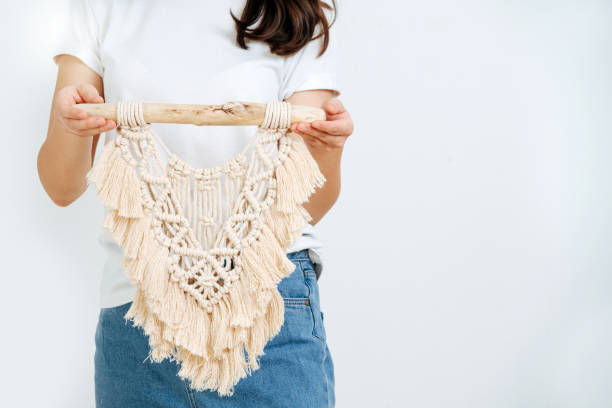 Closeup hand of girl, she shows macrame Closeup hand of girl, she shows macrame. The art of weaving knots of thick twisted threads, a product made in the technique of macrame. christmas human hand christmas ornament decoration stock pictures, royalty-free photos & images