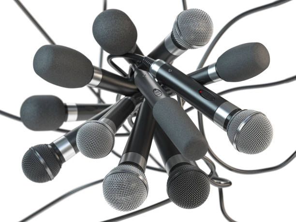 istock Many microphones isolated on white. Press conference or interview concept background. 1213271751