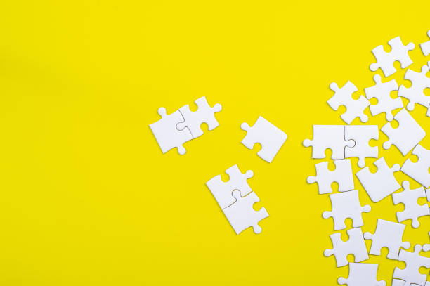istock White jigsaw puzzle on a yellow background 1213272533