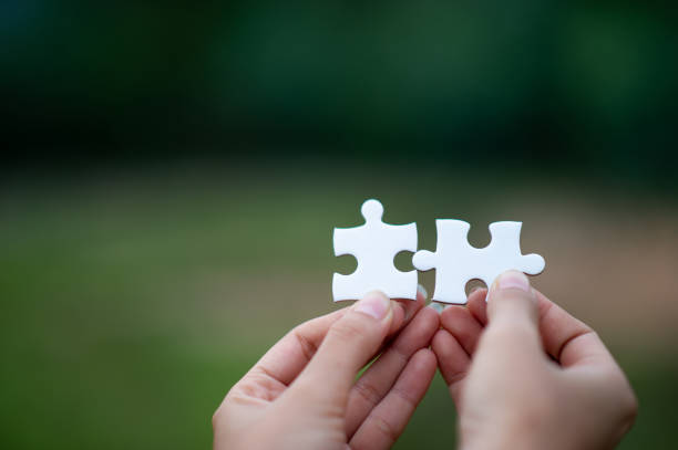 istock Hands and puzzles, important pieces of teamwork Teamwork concept 1213272645