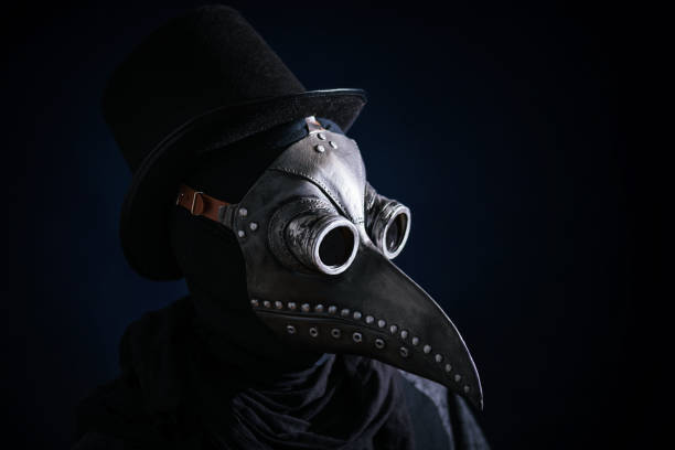 Masked man plague doctor, head profile, with bird mask and hat. Vintage style. Biohazard concept. Masked man plague doctor, head profile, with bird mask and hat. Vintage style. Biohazard concept. black plague doctor stock pictures, royalty-free photos & images