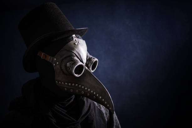 Masked man plague doctor, head profile, with bird mask and hat. Vintage style. Biohazard concept. Masked man plague doctor, head profile, with bird mask and hat. Vintage style. Biohazard concept. black plague doctor stock pictures, royalty-free photos & images