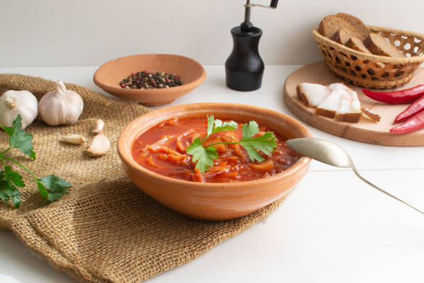 Red borsch. Ukrainian food. Rustic style. Red beetroot soup with beetroot, served with sour cream and garlic. stock photo