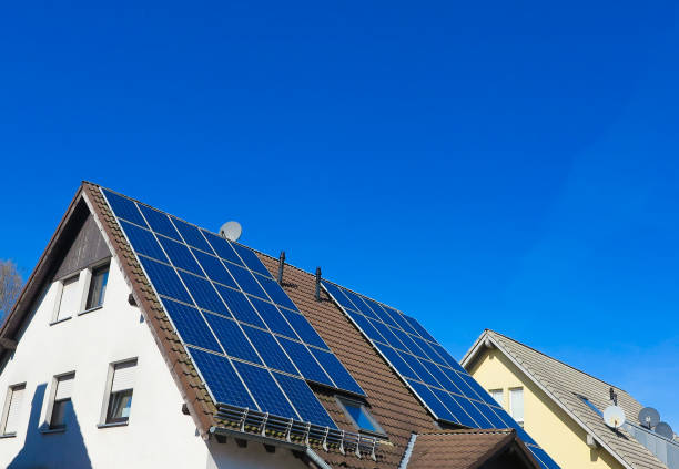 istock View on isolated german roof with solar panels against clear blue sky - Germany 1213275949