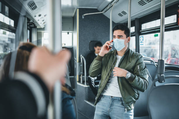 istock Men in bus wearing face mask-Covid-19 virus 1213276771