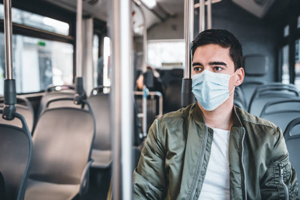 istock Men  in bus wearing face mask 1213277212