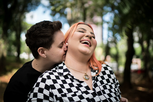 Lesbian couple embracing at park