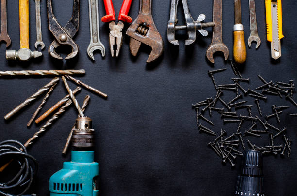 istock Tools for repair and reconstruction in home conditions lie on a black background 1213277781