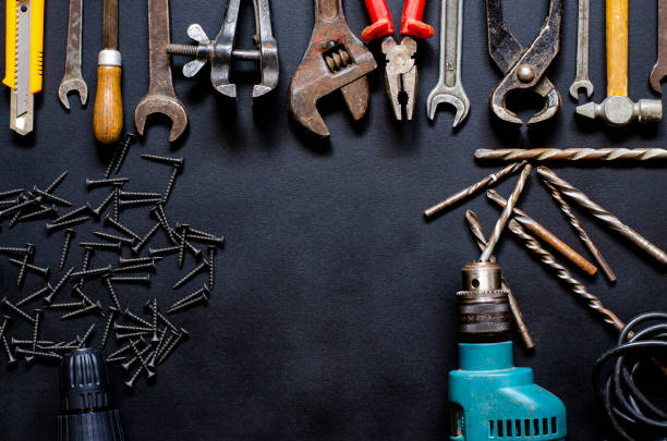 istock Tools for repair and reconstruction in home conditions lie on a black background 1213277802