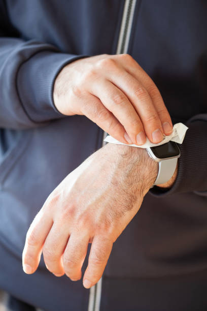 istock man hands disinfecting smart watch, eliminating germs coronavirus bacteria 1213279324