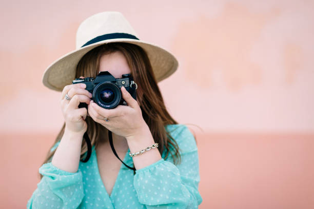 istock A young girl learns how to use her photo camera during a course 1213279527