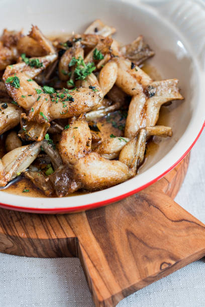 istock Fried frog legs on a wooden board 1213280256
