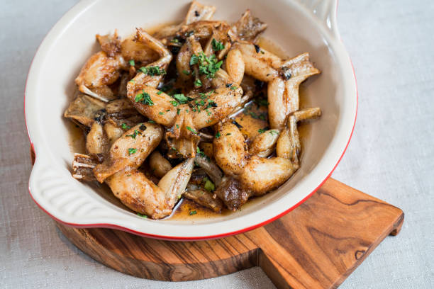 Fried frog legs on a wooden board