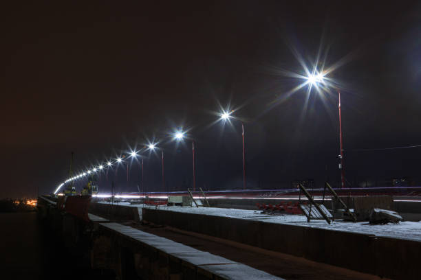 istock A row of street lamps at night on a bridge under construction 1213280949