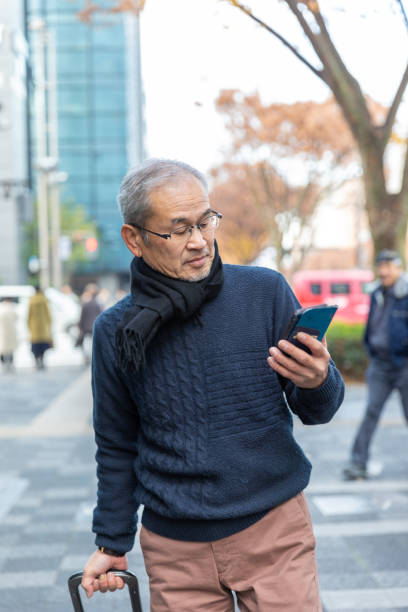 istock Senior man walking with suitcase 1213283957