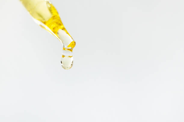 istock Oli drop on pipette on white background, macro. Close-up face moisturizer in glass dropper with copy space. Skincare beauty product and texture 1213284335