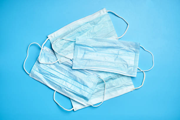 istock Several medical masks on a blue background. 1213285266