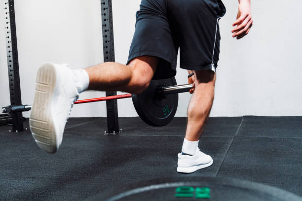 istock Rear view of a male performing a single leg weights exercise 1213287263