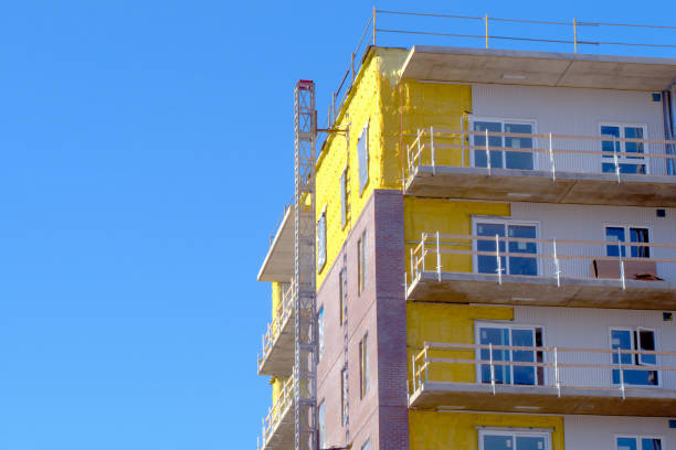 building construction yellow wall insulation facade work stock photo