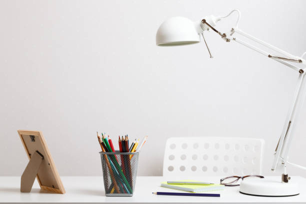 istock Comfortable desktop in home and office. Work lamp, stationery on the table 1213289775