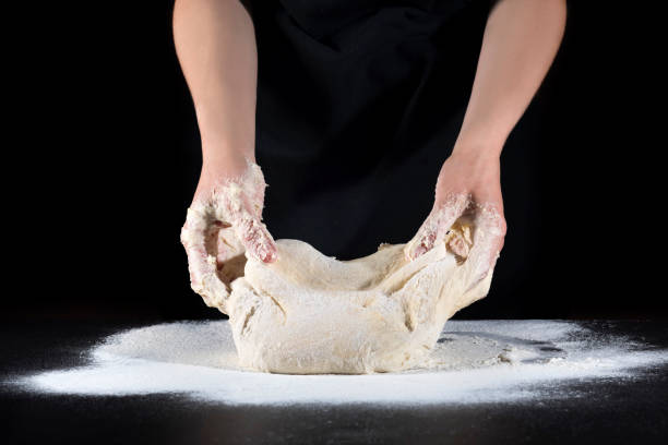 istock Chef's hands knead the dough. Cooking dough by hand in a bakery. 1213290703