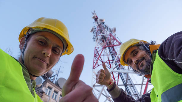istock Engineers working on the field near a Telecommunications tower. Teamwork. 1213293032