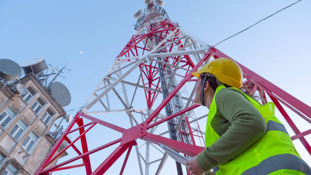 istock Female Engineer working on the field near a Telecommunications tower. 1213293035