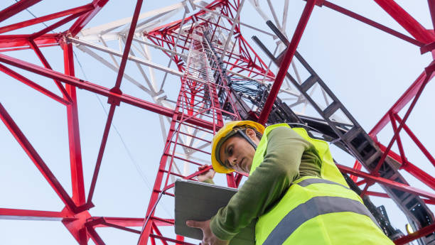 istock Female Engineer working on the field near a Telecommunications tower. 1213293177