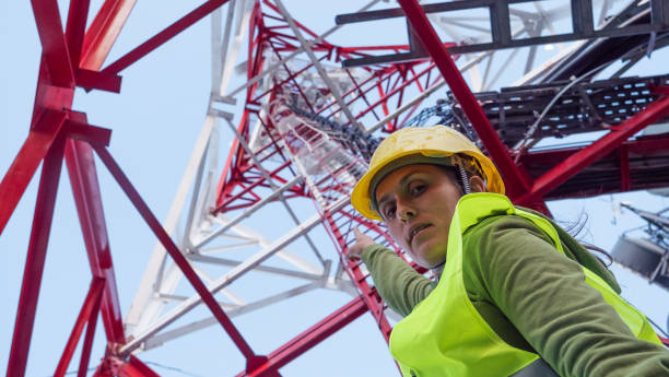 istock Female Engineer working on the field near a Telecommunications tower. 1213293182