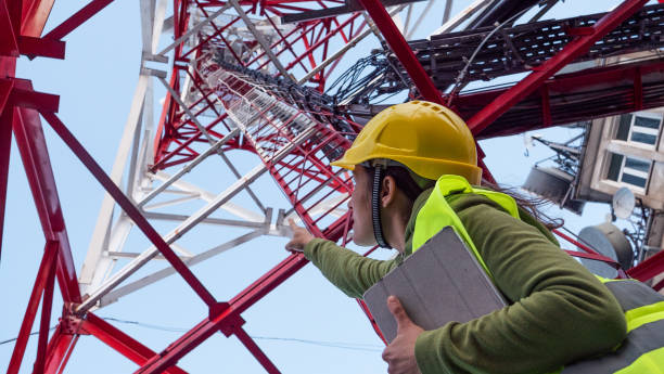 istock Female Engineer working on the field near a Telecommunications tower. 1213293201